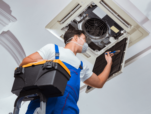 worker-repairing-ceiling-air-conditioning-unit 1-min